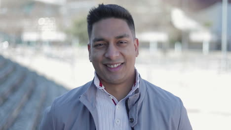 handsome smiling middle eastern man looking at camera