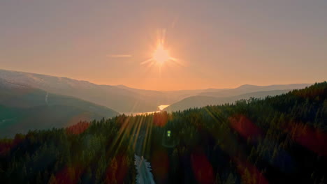 Drone-moving-over-Lysefjord-surrounded-by-rocky-mountains-in-Norway-during-evening-time