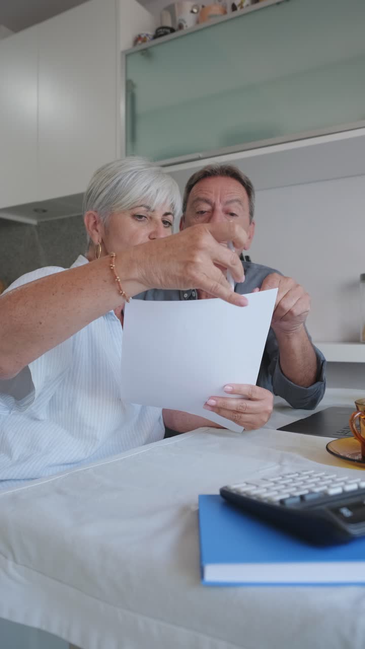 Older couple reviewing documents at home