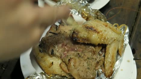 grilled seasoned chicken and pork in foil paper