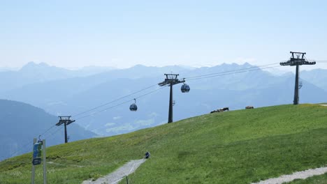 tracking shot, cable lifts transporting passengers above austrian resort