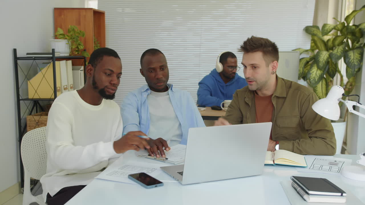 Diverse Startupers Looking at Business Plan on Laptop