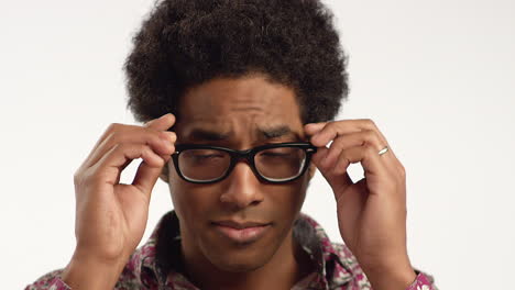 Close-up-Young-Man-Puts-Glasses-on