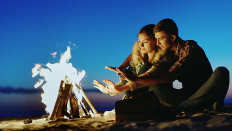 romantic couple relaxing on the beach she clung to the guy sunny and windy day in autumn