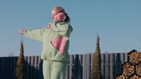 woman exercising outdoors in a light green tracksuit