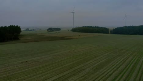 Imágenes-Aéreas-En-La-Mañana-Nublada-En-El-Parque-Eólico,-Molinos-De-Viento-Juntos-En-El-Campo