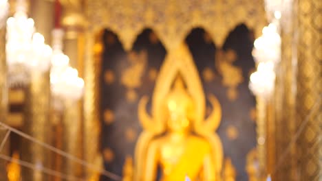 blurred of buddha statue in the church of temple background, thailand