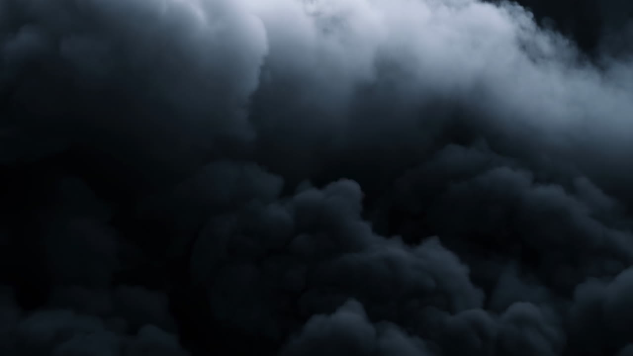 黒い背景で渦巻きながら動く濃い黒煙