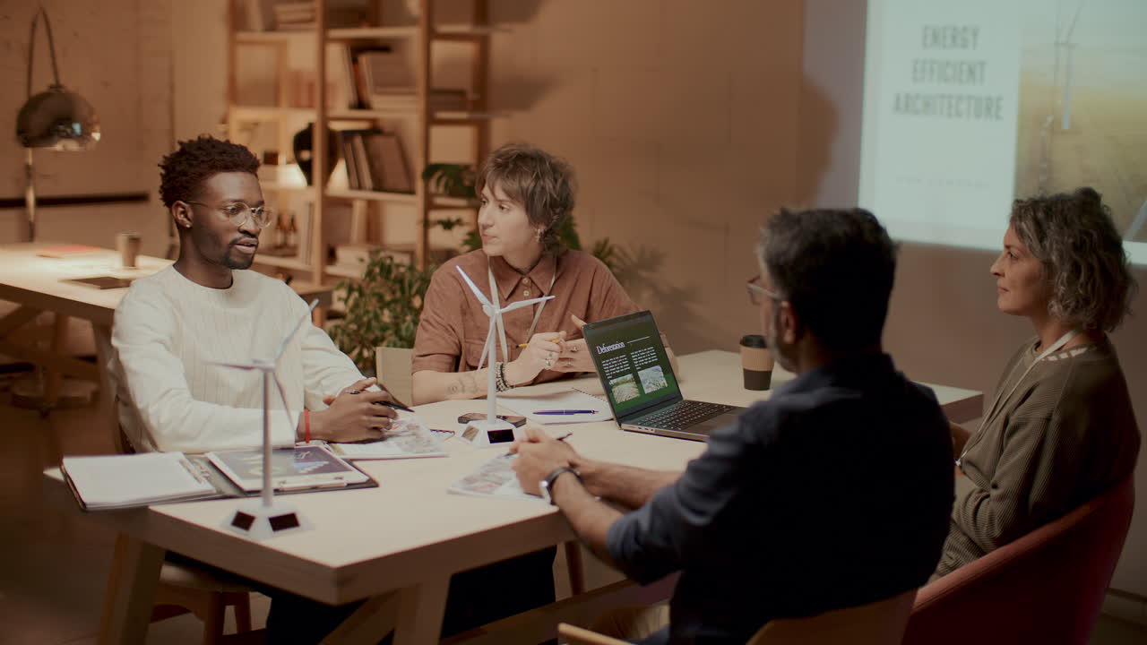 Multi-Ethnic Team Collaborating on Sustainable Energy Project in Office
