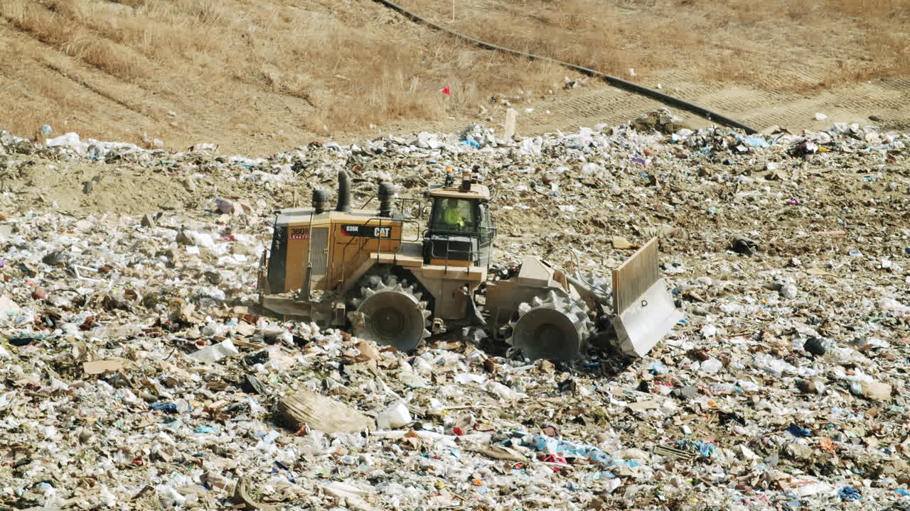 Heavy Equipment Compacting Waste at a Landfill