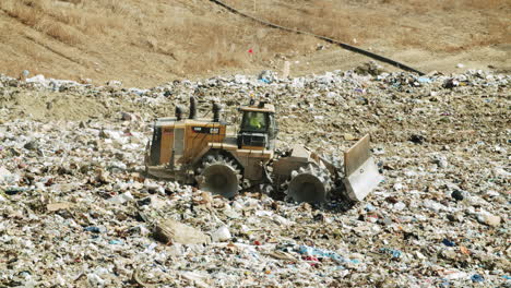 heavy equipment compacting waste at a landfill