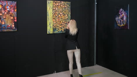 woman viewing art in an exhibition