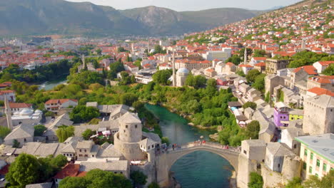 aerial of reconstructed mostar bridge at the historic city along neretva river in bosnia and herzegovina