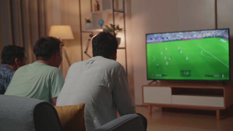 friends watching football game at home