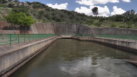 hydroelectric dam outflow water emerges from underground pipeline