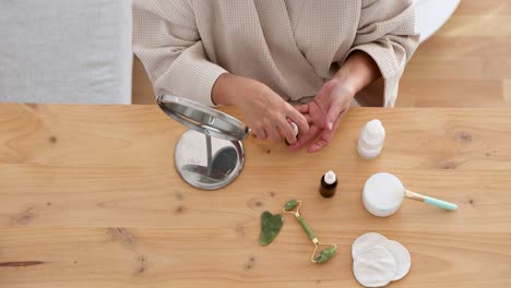 woman dripping cosmetic product on hand