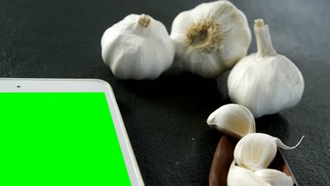 Garlic-with-digital-tablet-on-black-background-4k