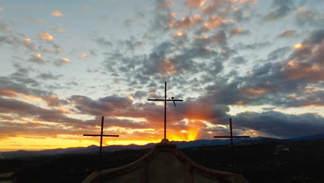 silhouette religion three christian crosses in orange sky at sunset in nature