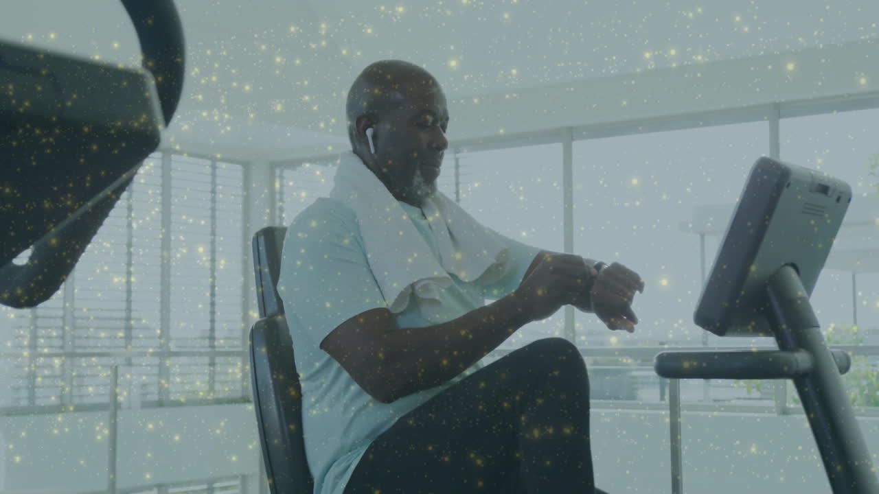 man pedaling on recumbent exercise bike in fitness room, showing animated heart icon and data chart