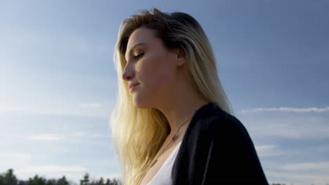 Strong-young-woman-looks-confidently-into-the-golden-sunset