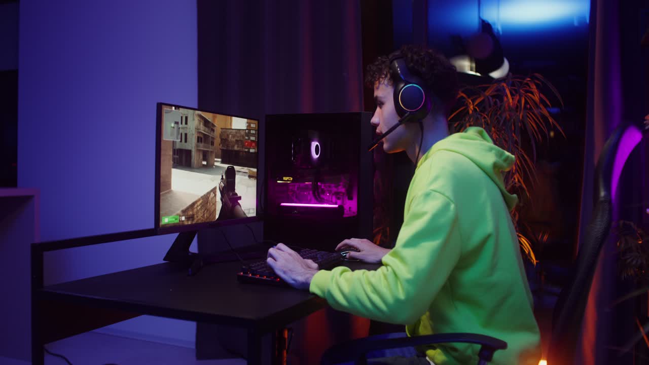 Gamer playing video game on computer