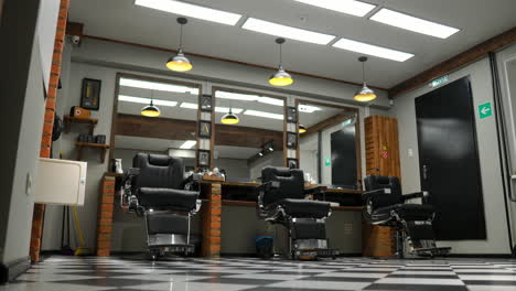 vintage hanging lamps in hairdressing salon. ceiling retro lamp in barber shop. barber pole. hair salon interior. metal ceiling lights in barbershop