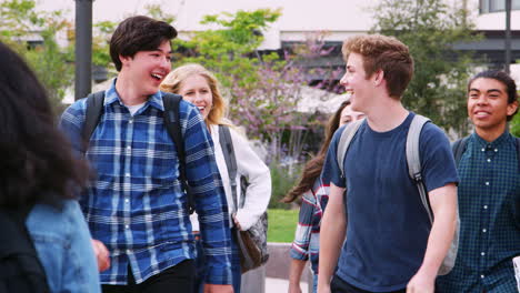 high school students socializing outside college buildings