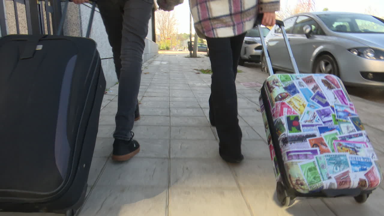 Couple Walking With Luggage