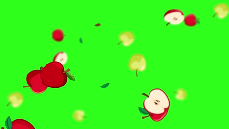 red and green apples falling on green backdrop