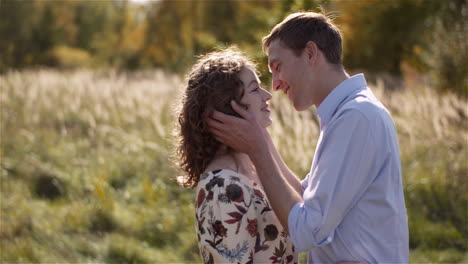 loving couple walking on a meadow in summer 20