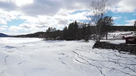 Camera-flows-over-a-guys-head,-watching-the-frozen-lake