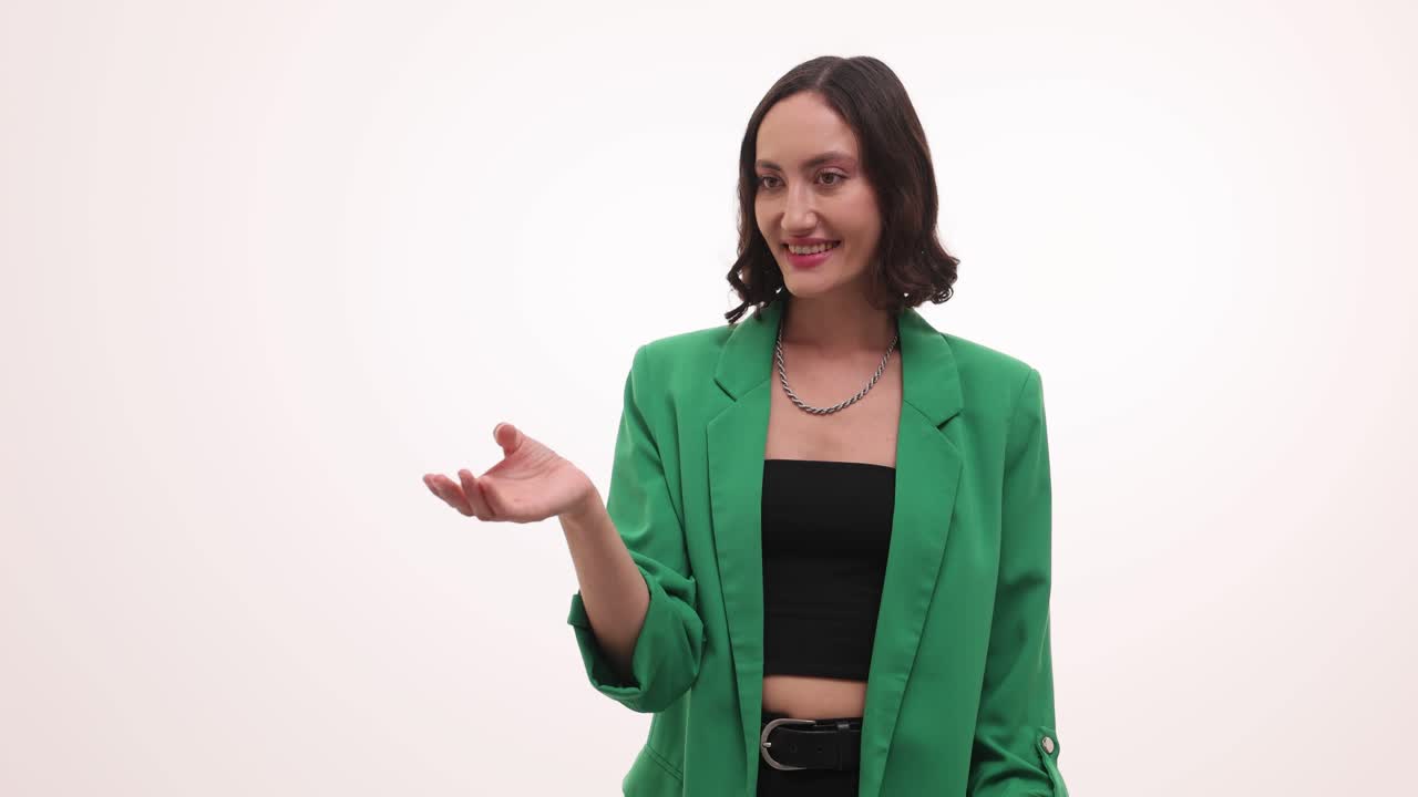 A young woman in a green blazer posing and expressing various gestures