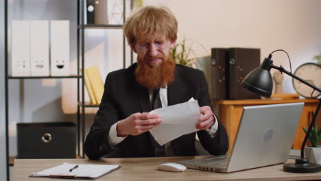 stressed businessman work at unpaid bank debt doing paperwork planning budget throws paper bills
