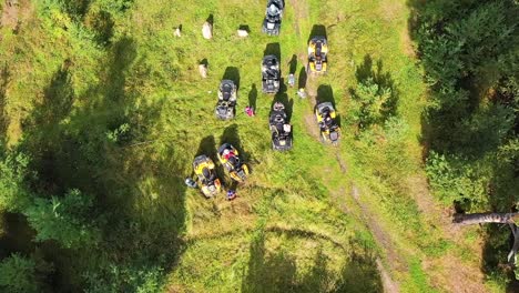 atv riders in a forest