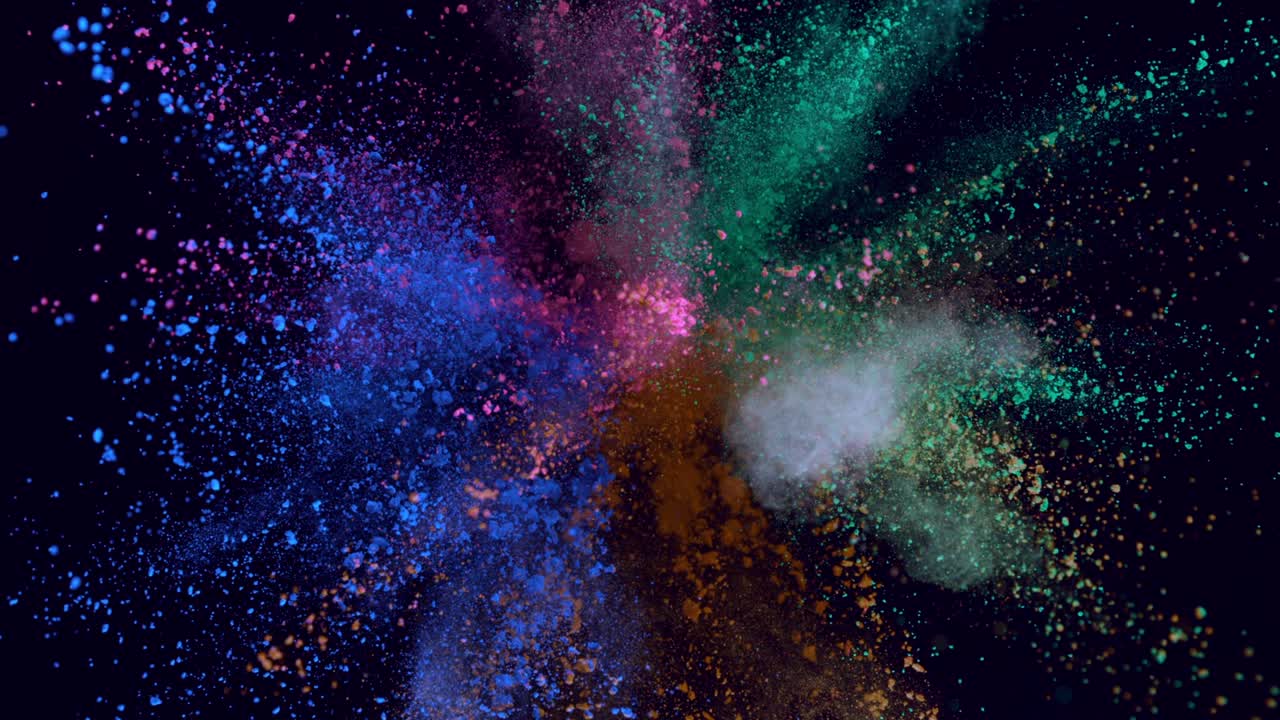 Explosión de polvo de colores en cámara superlenta aislada sobre fondo oscuro