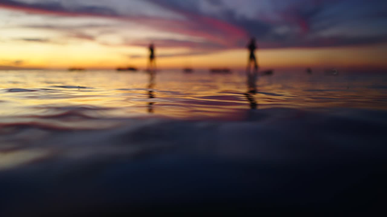 Silhouettes on Water at Sunset