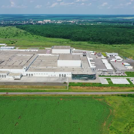 production plant among green nature. industrial complex near the road in the countryside. aerial view.