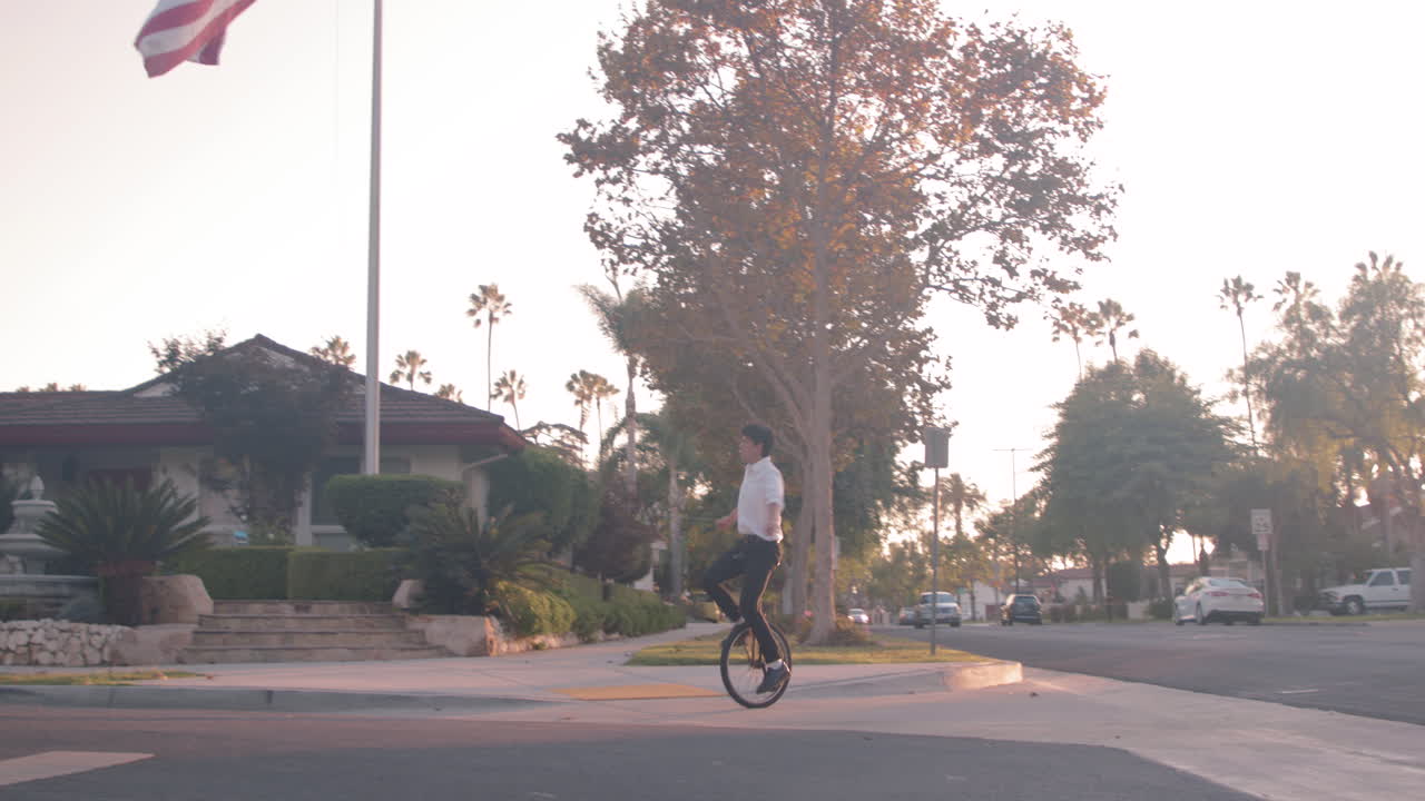 Unicyclist near American Flag