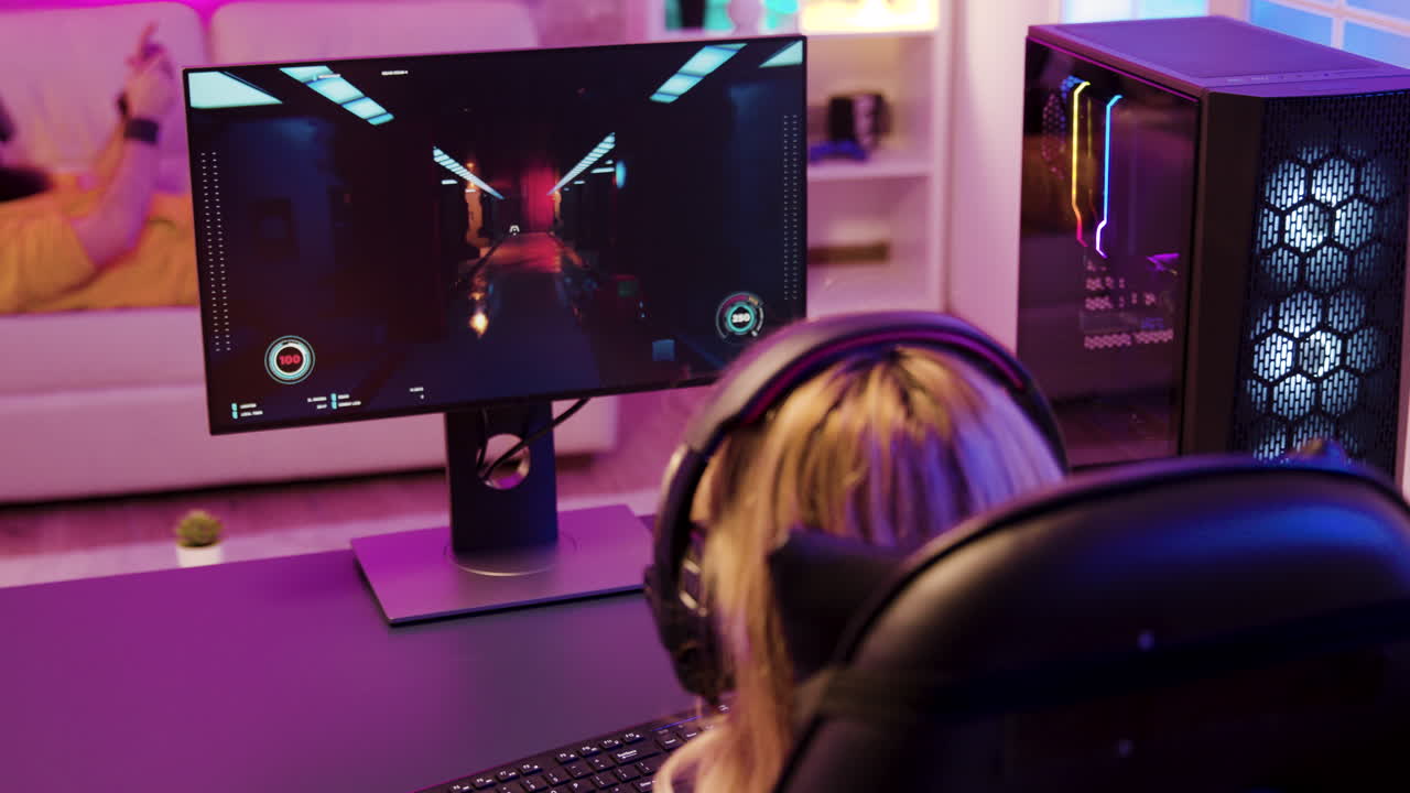 Woman playing video game on computer