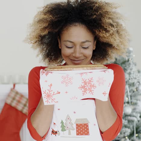 happy young woman holding a christmas pastry