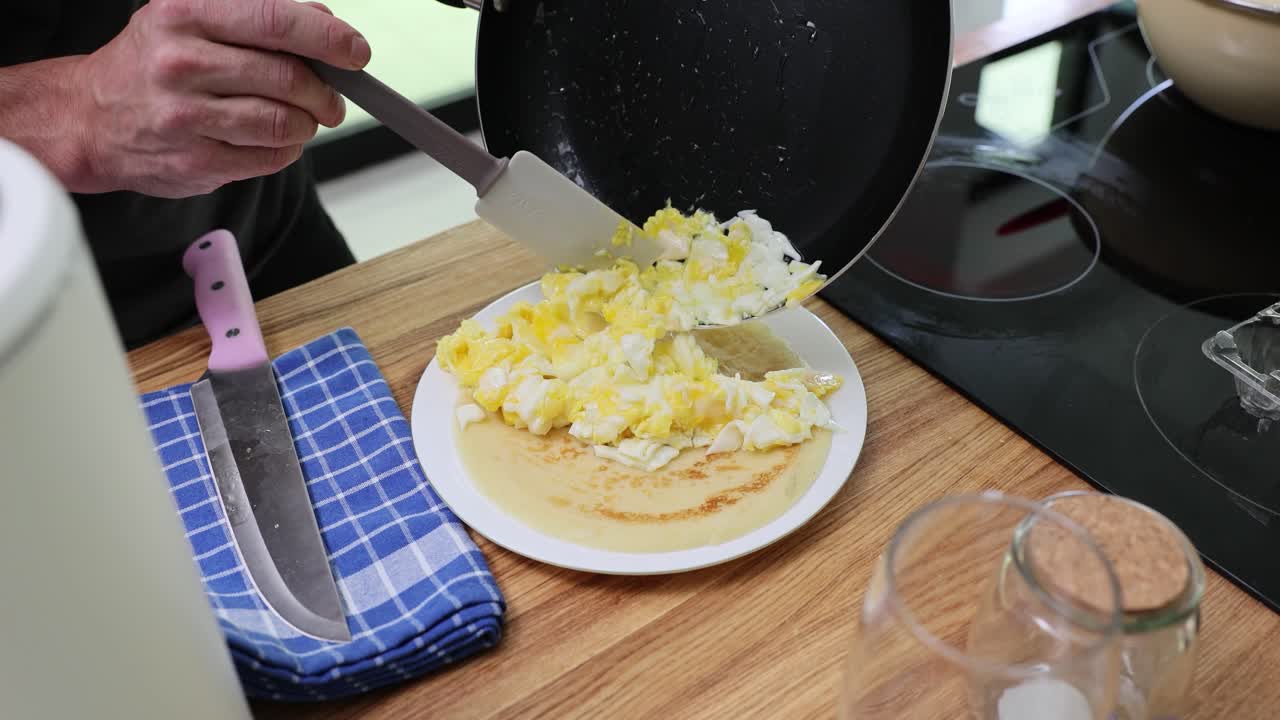 Preparing scrambled eggs and pancake