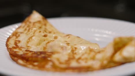 freshly cooked delicious pancake on plate with shallow dof. traditional british dessert or breakfast ready to eat. plated food product photography.