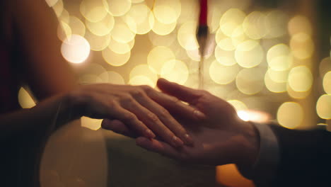 evening couple touching hands at blurred background closeup. happy woman talking