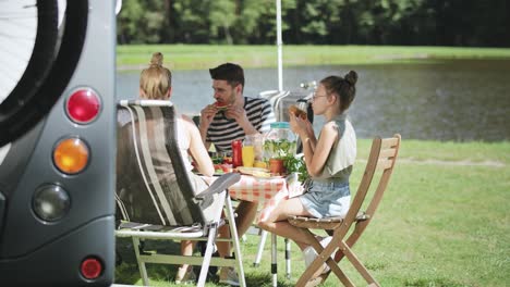 handheld video of family relaxing during lunch on camper trip