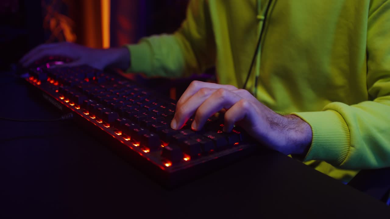 Person gaming with a neon keyboard