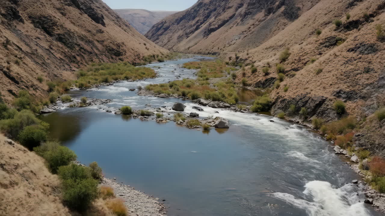 A river flows through a scenic canyon landscape
