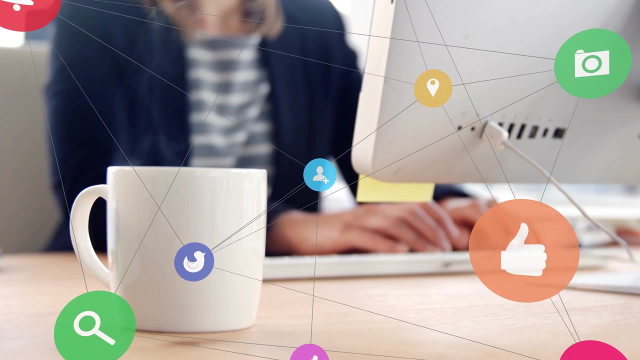 Mid-adult female typing at desk, icons shifting, growing and clustering around mug for marketing