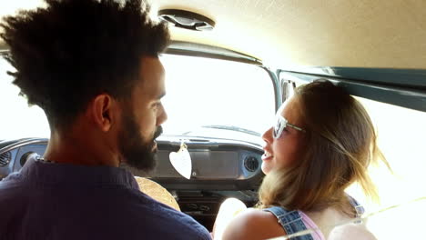 Mixed-race-couple-on-sitting-in-the-front-of-camper-van