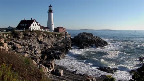 the portland head lighthouse oversees the ocean from rocks in maine new england  6