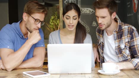 group of friends discussing over laptop 4k